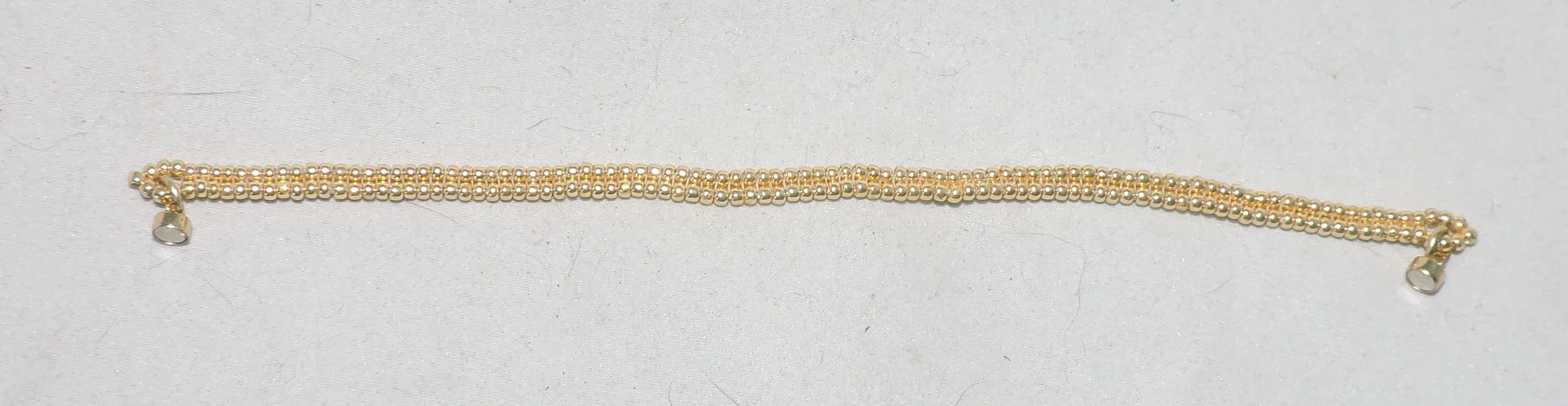 Bracelet of Sleek and Delicate Gold Beads